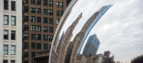 Cityscape reflected in sculpture in Chicago, a city served by Trailways bus service